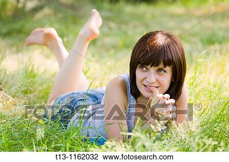 Lying on grass with a thumb in her mouth View Large Photo Image Stock Image - Lying on grass with a thumb in her mouth. Fotosearch