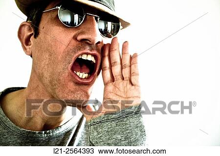 Stock Image - Man shouting with sunglasses and hat.. Fotosearch