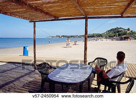 Man sitting in a terrace in Marianeta Cassiana beach. Denia, Alicante province, Comunidad Valenciana, Spain. View Large Photo Image Picture - Man sitting in a terrace in Marianeta Cassiana beach. Denia, Alicante province, Comunidad Valenciana, Spain.. Fotosearch