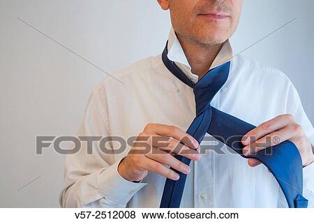 Man tie his necktie. Close view. View Large Photo Image Stock Photo - Man tie his necktie. Close view.. Fotosearch