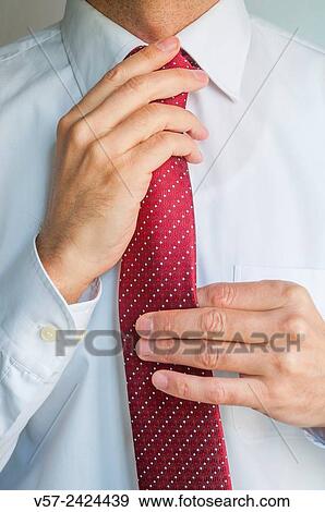 Man tying his tie. Close view. View Large Photo Image Stock Photo - Man tying his tie. Close view.. Fotosearch