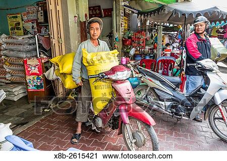 Man with 150kg of rice on motor scooter at the local market in Chau Doc, Vietnam. View Large Photo Image Stock Image - Man with 150kg of rice on motor scooter at the local market in Chau Doc, Vietnam.. Fotosearch