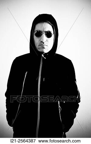 Man with round sunglasses and the hood of his sweatshirt set. View Large Photo Image Stock Photo - Man with round sunglasses and the hood of his sweatshirt set.. Fotosearch