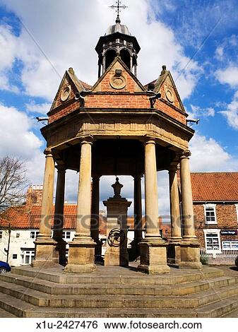 Stock Photograph - Market Cross and Pump in St James Square Boroughbridge North Yorkshire England.. Fotosearch