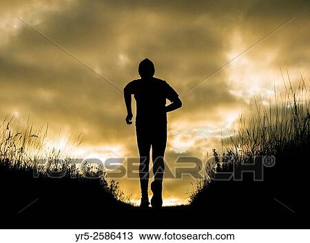 Mature male runner stops to watch the sun rise. Cowpen Woodland Park, Billingham, England, United Kingdom. View Large Photo Image Stock Image - Mature male runner stops to watch the sun rise. Cowpen Woodland Park, Billingham, England, United Kingdom.. Fotosearch