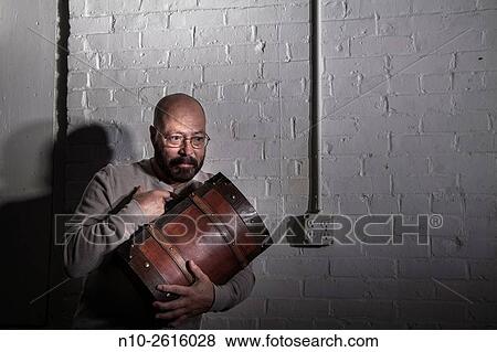 Middle age bald man with a beard and glasses, holding a wooden case. View Large Photo Image Stock Photo - Middle age bald man with a beard and glasses, holding a wooden case.. Fotosearch
