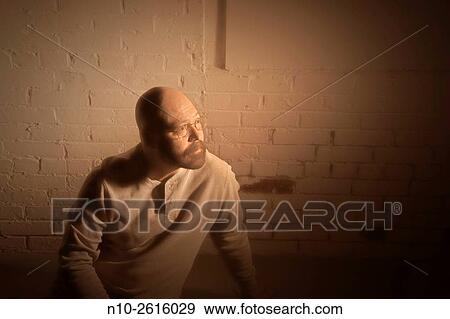 Middle age bald man with a beard and glasses, sitting on the floor. View Large Photo Image Stock Photo - Middle age bald man with a beard and glasses, sitting on the floor.. Fotosearch