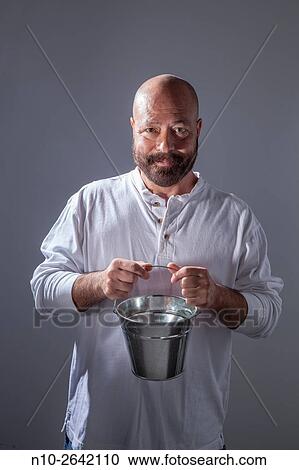 Middle age bald man with a beard, holding a metal bucket. View Large Photo Image Stock Image - Middle age bald man with a beard, holding a metal bucket.. Fotosearch