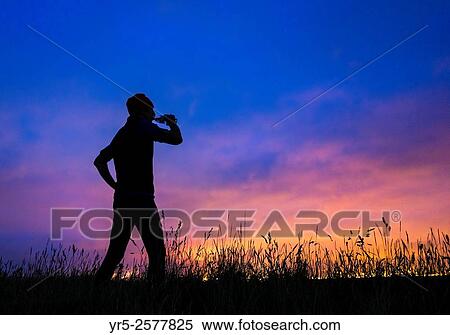 Monday 7th September 2015, Cowpen Bewley Woodland Park, Billingham, north east England. Weather: Jogger on hill in woodland park silhouetted against glow from Teesside`s industrial skyline in pre dawn light on Monday morning. View Large Photo Image Stock Photography - Monday 7th September 2015, Cowpen Bewley Woodland Park, Billingham, north east England. Weather: Jogger on hill in woodland park silhouetted against glow from Teesside`s industrial skyline in pre dawn light on Monday morning.. Fotosearch