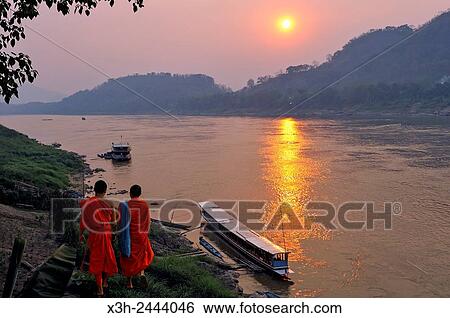 monks at sunset on Mekong River at Luang Prabang, Laos, Southeast Asia. View Large Photo Image Stock Photograph - monks at sunset on Mekong River at Luang Prabang, Laos, Southeast Asia.. Fotosearch