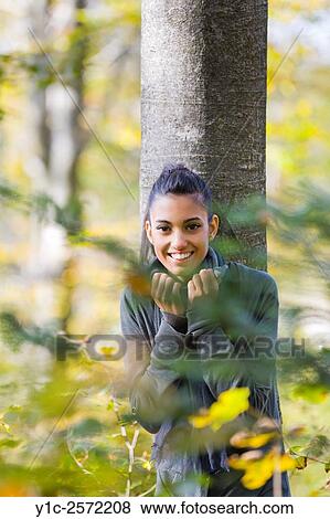Mulatto teen girl in forest before tree through branches View Large Photo Image Stock Photo - Mulatto teen girl in forest before tree through branches. Fotosearch