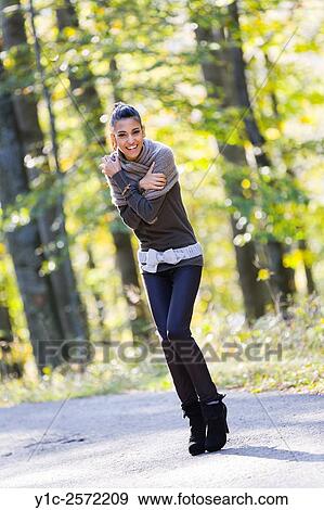 Stock Photo - Mulatto teen-girl on country road is cold. Fotosearch