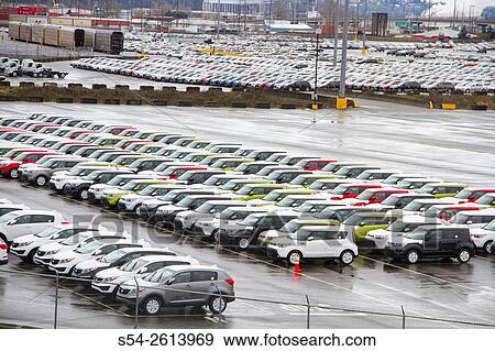 Stock Photo - New vehicles unloaded from a ship at the Port of Tacoma, Washington, USA.. Fotosearch