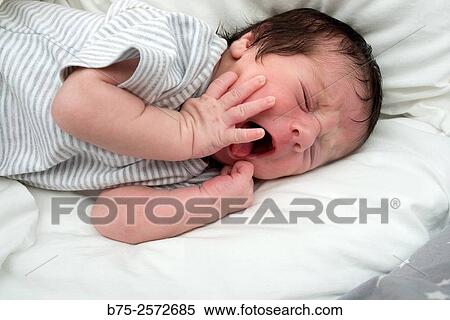Newborn baby girl sleeping and yawning in her cradle. View Large Photo Image Stock Photography - Newborn baby girl sleeping and yawning in her cradle.. Fotosearch