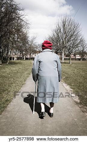 Ninety year old woman walking in Public park in England. United Kingdom. View Large Photo Image Stock Photo - Ninety year old woman walking in Public park in England. United Kingdom.. Fotosearch