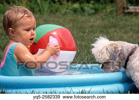 North America, Canada, Ontario, child playing in plastic inflatible pool. View Large Photo Image Stock Photo - North America, Canada, Ontario, child playing in plastic inflatible pool.. Fotosearch