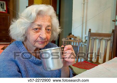 Old woman at home, drinking coffee and looking at the camera. View Large Photo Image Stock Image - Old woman at home, drinking coffee and looking at the camera.. Fotosearch