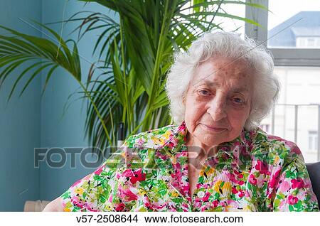 Old woman in a nursing home, smiling and looking at the camera. View Large Photo Image Picture - Old woman in a nursing home, smiling and looking at the camera.. Fotosearch