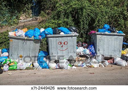 Overflowing rubbish bins waiting to be emptied, Outer Mani, Messenia, Peloponnese, Greece. View Large Photo Image Stock Photograph - Overflowing rubbish bins waiting to be emptied, Outer Mani, Messenia, Peloponnese, Greece.. Fotosearch