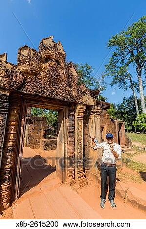 Park guide near red sandstone entrance at Banteay Srei Temple in Angkor, Siem Reap Province, Cambodia, Khmer. View Large Photo Image Stock Image - Park guide near red sandstone entrance at Banteay Srei Temple in Angkor, Siem Reap Province, Cambodia, Khmer.. Fotosearch