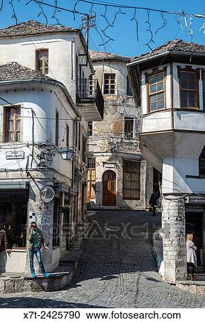 Passing the time of day on the main street in the bazaar area of Gjirokastra in southern Albania. View Large Photo Image Stock Image - Passing the time of day on the main street in the bazaar area of Gjirokastra in southern Albania.. Fotosearch
