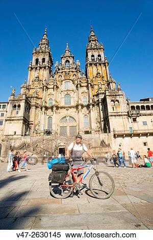 Pilgrim on his arrival in the Plaza del Obradoiro posing in front of the camera with the bike and saddlebags, behind the facade of the Cathedral of Santiago de Compostela, Spain. This is the final point on the pilgrimage route. View Large Photo Image Stock Photography - Pilgrim on his arrival in the Plaza del Obradoiro posing in front of the camera with the bike and saddlebags, behind the facade of the Cathedral of Santiago de Compostela, Spain. This is the final point on the pilgrimage route.. Fotosearch