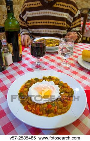 Pisto manchego with fried egg in a restaurant. Madrid, Spain. View Large Photo Image Stock Photography - Pisto manchego with fried egg in a restaurant. Madrid, Spain.. Fotosearch
