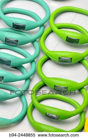 Stock Photography - Plastic watches in different colors for sale.. Fotosearch
