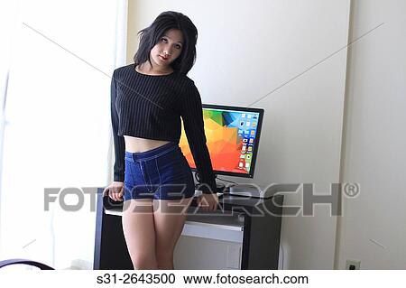 portrait of a beautiful young asian girl from canada posing in front of a monitor. View Large Photo Image Stock Image - portrait of a beautiful young asian girl from canada posing in front of a monitor.. Fotosearch