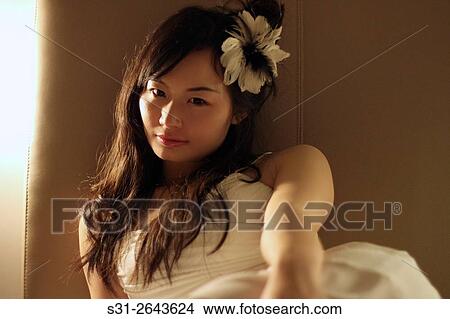 portrait of a beautiful young Chinese girl playing on bed. View Large Photo Image Picture - portrait of a beautiful young Chinese girl playing on bed.. Fotosearch
