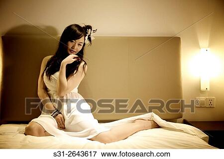portrait of a beautiful young Chinese girl playing on bed. View Large Photo Image Stock Photo - portrait of a beautiful young Chinese girl playing on bed.. Fotosearch