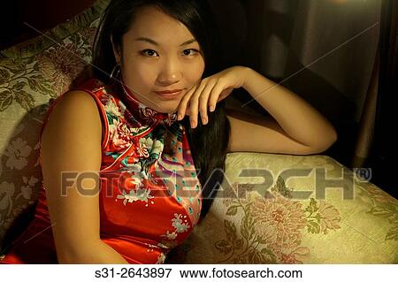 portrait of a beautiful young Chinese girl wearing a traditional Chinese dress qipao. View Large Photo Image Stock Photo - portrait of a beautiful young Chinese girl wearing a traditional Chinese dress qipao.. Fotosearch
