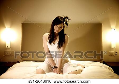 portrait of a beautiful young Chinese girl playing on bed. View Large Photo Image Stock Photograph - portrait of a beautiful young Chinese girl playing on bed.. Fotosearch