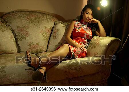 portrait of a beautiful young Chinese girl wearing a traditional Chinese dress qipao. View Large Photo Image Stock Photograph - portrait of a beautiful young Chinese girl wearing a traditional Chinese dress qipao.. Fotosearch