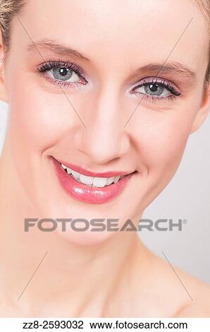 Stock Image - Portrait of a happy young woman smiling.. Fotosearch