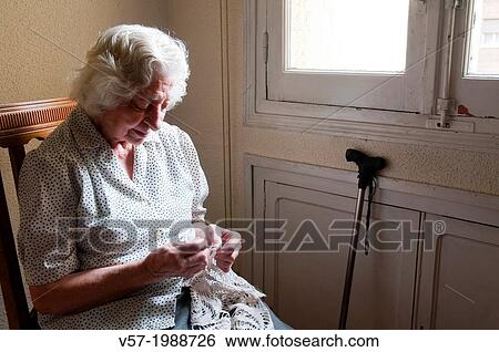 Portrait of elderly woman crochetting at home, by the window. View Large Photo Image Stock Photograph - Portrait of elderly woman crochetting at home, by the window.. Fotosearch