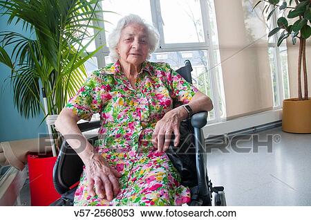 Portrait of elderly woman, sitting in a wheelchair in a nursing home. View Large Photo Image Stock Image - Portrait of elderly woman, sitting in a wheelchair in a nursing home.. Fotosearch