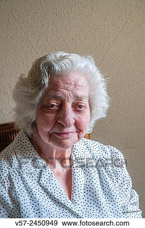 Portrait of elderly woman smiling and looking at the camera. View Large Photo Image Stock Photo - Portrait of elderly woman smiling and looking at the camera.. Fotosearch