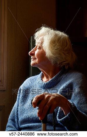 Portrait of old woman at home, smiling and looking at the window. Low key. View Large Photo Image Stock Photograph - Portrait of old woman at home, smiling and looking at the window. Low key.. Fotosearch