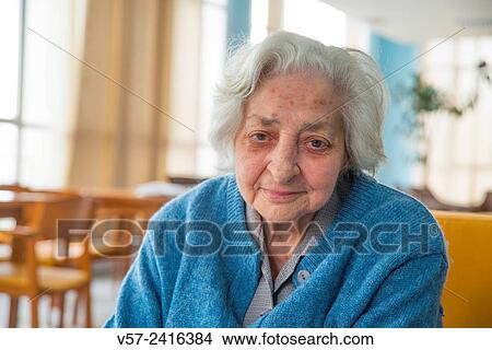 Portrait of old woman in a nursing home, smiling and looking at the camera. View Large Photo Image Picture - Portrait of old woman in a nursing home, smiling and looking at the camera.. Fotosearch