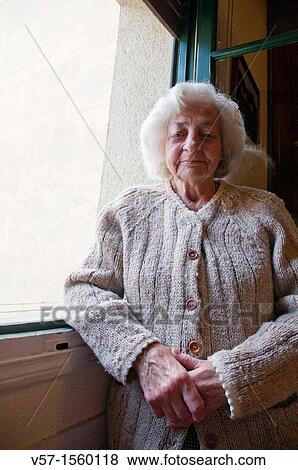 Portrait of old woman posing by the window View Large Photo Image Stock Photo - Portrait of old woman posing by the window. Fotosearch