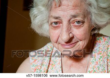 Portrait of old woman smiling and looking at the camera. Close view. View Large Photo Image Stock Photograph - Portrait of old woman smiling and looking at the camera. Close view.. Fotosearch