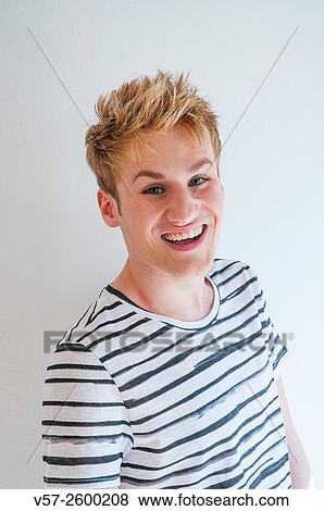 Portrait of young man laughing and looking at the camera. View Large Photo Image Stock Photo - Portrait of young man laughing and looking at the camera.. Fotosearch