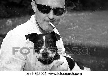 Portrait of young man with Jack Russell pet dog View Large Photo Image Stock Photography - Portrait of young man with Jack Russell pet dog. Fotosearch