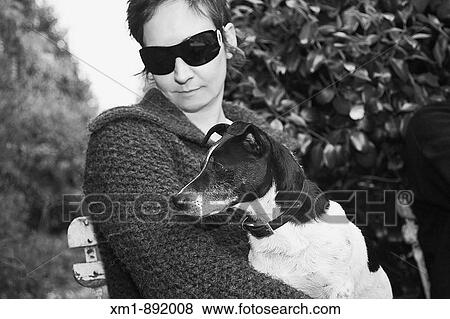 Stock Photo - Portrait of young woman with Jack Russell dog. Fotosearch