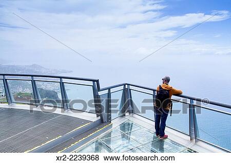 Portugal, Madeira, Funchal, Cabo Girao, Tourist looking at city View Large Photo Image Stock Photo - Portugal, Madeira, Funchal, Cabo Girao, Tourist looking at city. Fotosearch