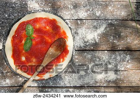 Preparing pizza made with tomato basil and mozzarella. View Large Photo Image Stock Image - Preparing pizza made with tomato basil and mozzarella.. Fotosearch