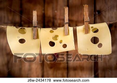 Presentation of slices of Swiss cheese Emmentaler hanging by a thread. View Large Photo Image Stock Photo - Presentation of slices of Swiss cheese Emmentaler hanging by a thread.. Fotosearch