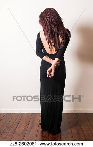 Rear view of a woman in black dress. View Large Photo Image Stock Image - Rear view of a woman in black dress.. Fotosearch