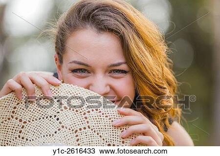 Reluctant behind Summer hat View Large Photo Image Stock Image - Reluctant behind Summer hat. Fotosearch